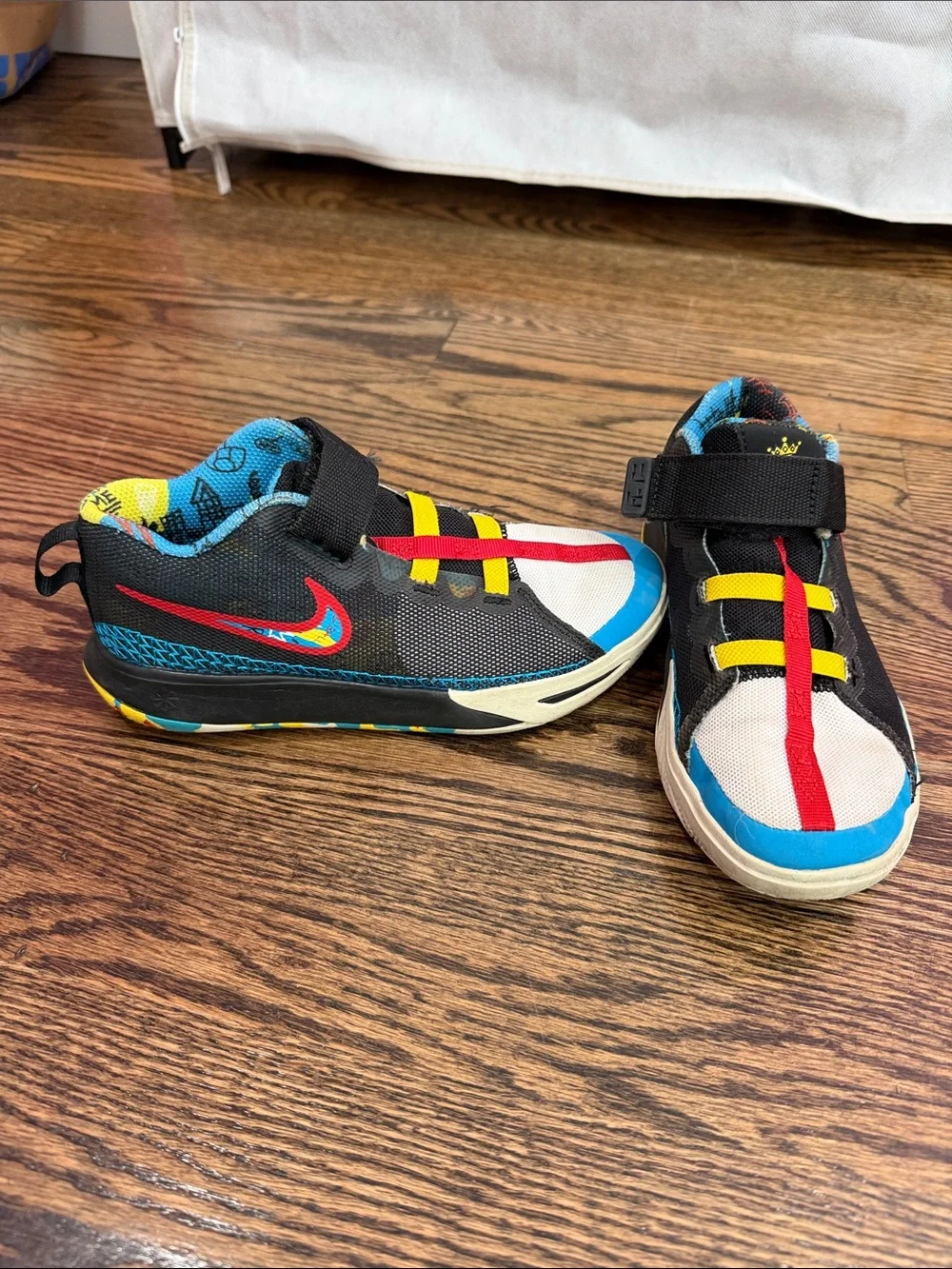 Nike Kids Black Sneakers with Blue, Red and Yellow Accents